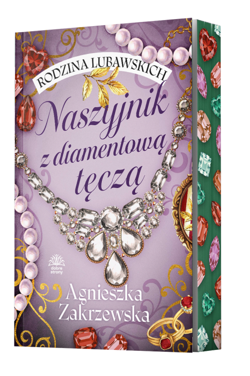 Fioletowa okładka z dużym, misternie zdobionym naszyjnikiem z diamentów i kolorowych kamieni, tworzących efekt tęczy. U góry widnieje nazwa serii Rodzina Lubawskich, a na dole nazwisko autorki, Agnieszki Zakrzewskiej.